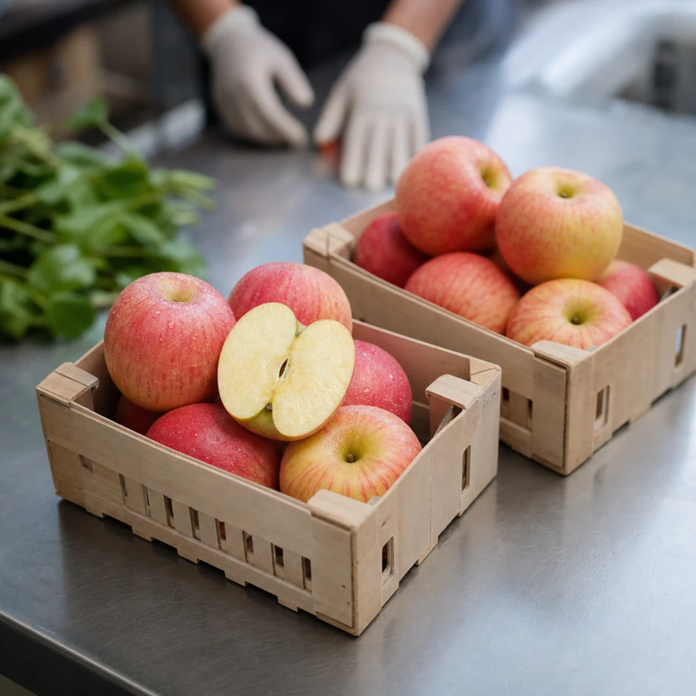 Fuji-style apple samples on a grading table.